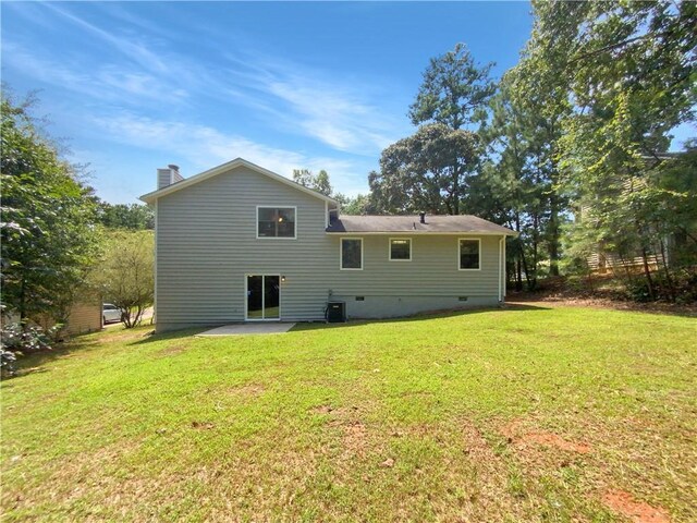 back of house with a patio, a yard, and central AC unit