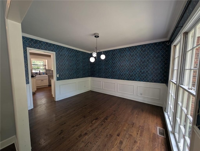 5882 Grandview Ct NW, Acworth, GA 30101 - unfurnished dining area with ornamental molding, wallpapered walls, dark wood-style floors, a wainscoted wall, and a decorative wall