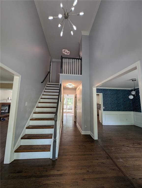 5882 Grandview Ct NW, Acworth, GA 30101 - stairs with high vaulted ceiling, a chandelier, wood finished floors, and ornamental molding