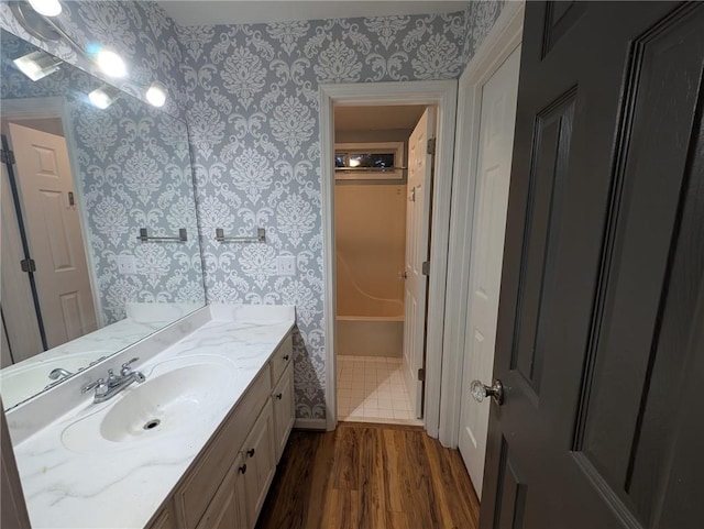 5882 Grandview Ct NW, Acworth, GA 30101 - bathroom featuring wallpapered walls, wood finished floors, vanity, and a bathtub