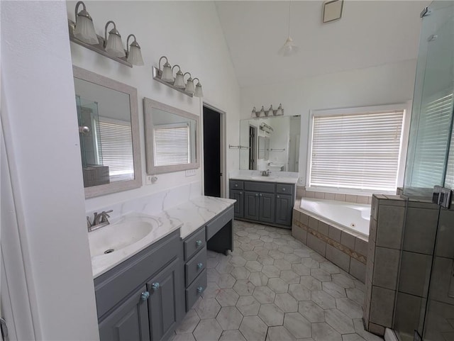 5882 Grandview Ct NW, Acworth, GA 30101 - full bathroom with vaulted ceiling, a garden tub, tile patterned floors, two vanities, and a shower