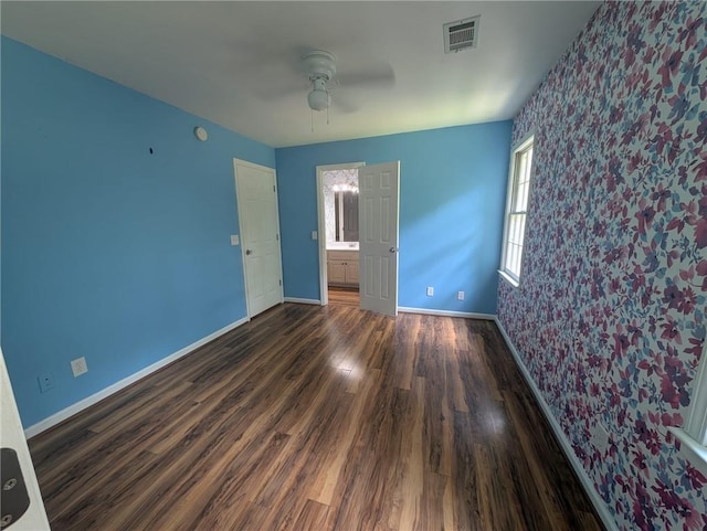 5882 Grandview Ct NW, Acworth, GA 30101 - unfurnished bedroom featuring wallpapered walls, wood finished floors, ensuite bath, an accent wall, and ceiling fan