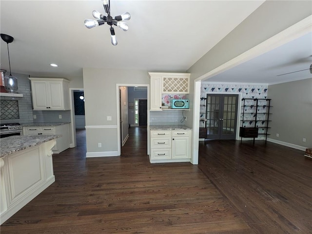 5882 Grandview Ct NW, Acworth, GA 30101 - kitchen with tasteful backsplash, a chandelier, french doors, white cabinetry, and light stone counters