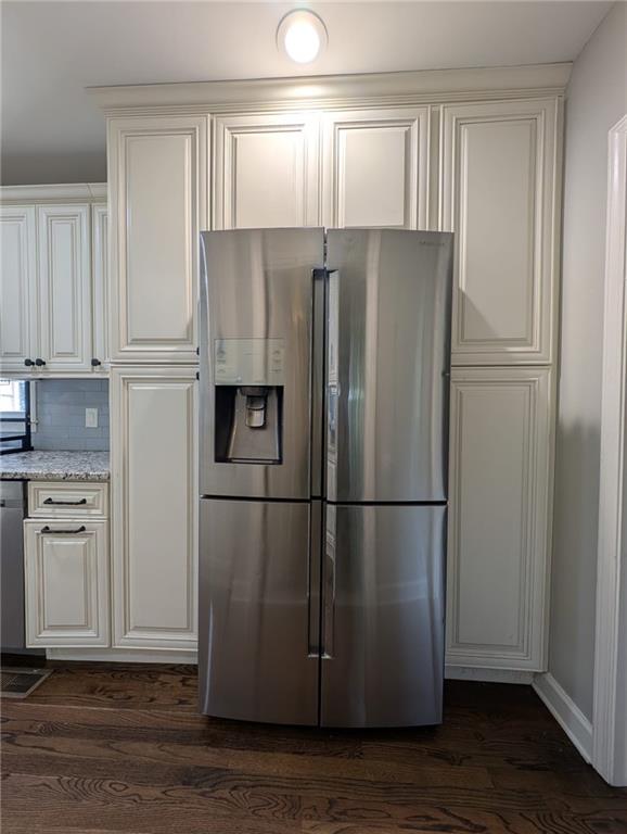 5882 Grandview Ct NW, Acworth, GA 30101 - kitchen with stainless steel refrigerator with ice dispenser, dark wood-style floors, light stone countertops, white cabinetry, and tasteful backsplash