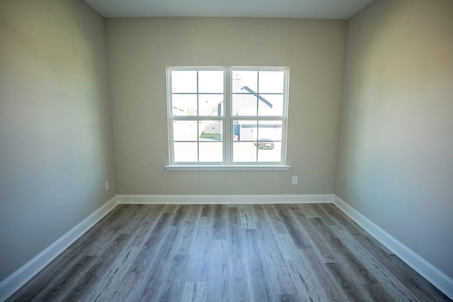 unfurnished room featuring hardwood / wood-style flooring