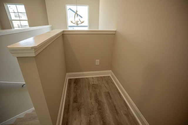 interior space featuring an inviting chandelier and hardwood / wood-style flooring