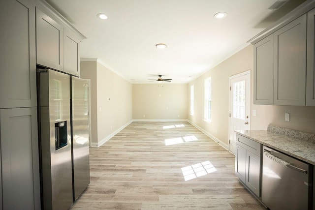 kitchen with stainless steel appliances, light stone countertops, gray cabinetry, and light hardwood / wood-style flooring