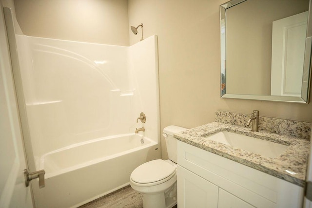 full bathroom featuring vanity, hardwood / wood-style floors, shower / bathtub combination, and toilet