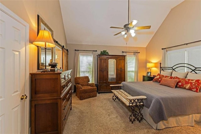 bedroom with a barn door, carpet flooring, ceiling fan, and high vaulted ceiling