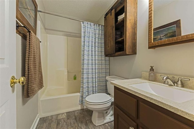 full bathroom with shower / bath combo, a textured ceiling, toilet, vanity, and hardwood / wood-style flooring