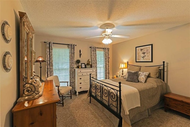 bedroom with carpet floors, a textured ceiling, and ceiling fan