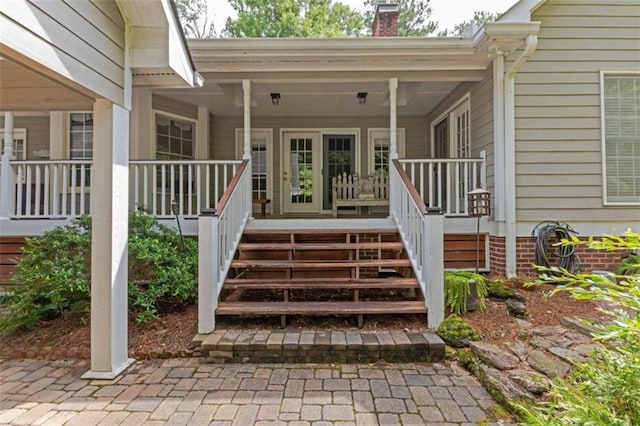 view of exterior entry featuring a porch