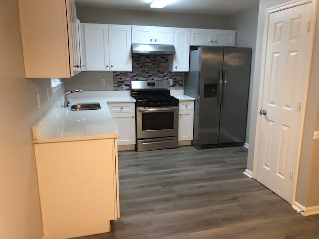 kitchen with sink, backsplash, stainless steel appliances, white cabinets, and dark hardwood / wood-style flooring