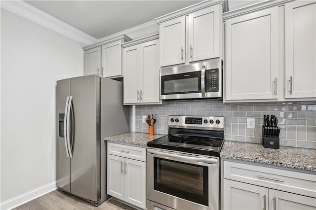 348 Meeler Cir, Bogart, GA 30622 - kitchen featuring stainless steel appliances, ornamental molding, tasteful backsplash, light stone counters, and light wood-style floors