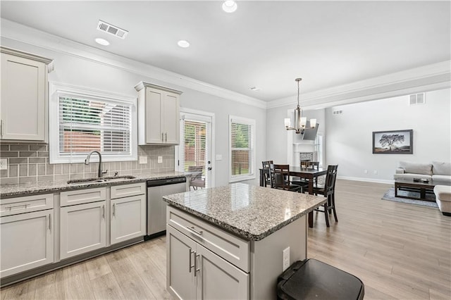 348 Meeler Cir, Bogart, GA 30622 - kitchen featuring stainless steel dishwasher, light wood finished floors, a chandelier, crown molding, and open floor plan