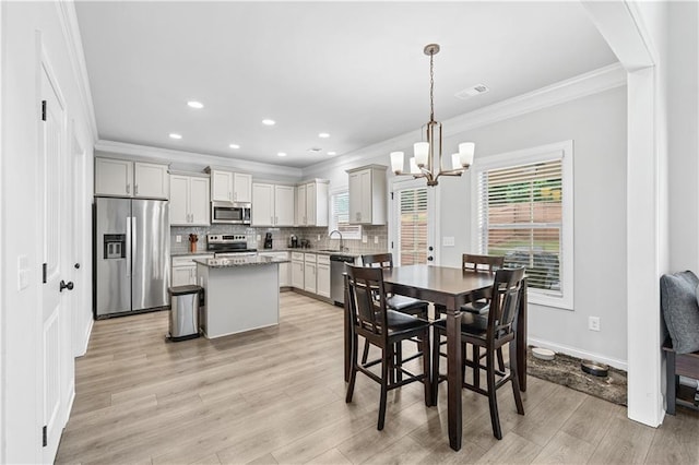 348 Meeler Cir, Bogart, GA 30622 - dining room featuring crown molding, a chandelier, light wood finished floors, healthy amount of natural light, and recessed lighting