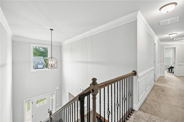 348 Meeler Cir, Bogart, GA 30622 - hall with an upstairs landing, carpet flooring, ornamental molding, a chandelier, and a decorative wall