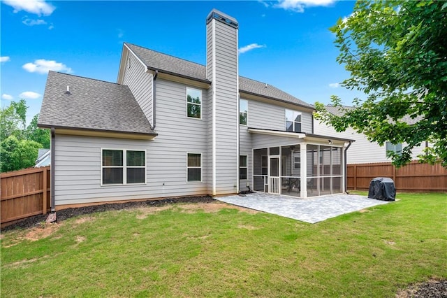 348 Meeler Cir, Bogart, GA 30622 - back of house with a sunroom, a patio, a fenced backyard, a chimney, and roof with shingles
