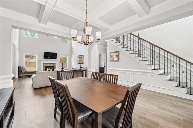 348 Meeler Cir, Bogart, GA 30622 - dining room with a brick fireplace, stairway, beamed ceiling, coffered ceiling, and light wood-style floors