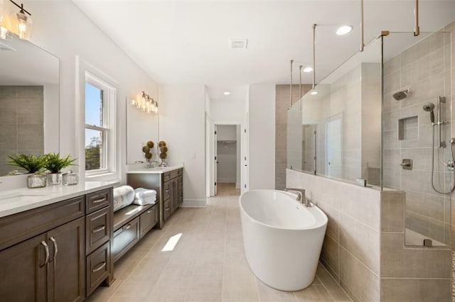 5247 Flannery Chase SW, Powder Springs, GA 30127 - bathroom featuring a shower stall, a freestanding bath, vanity, tile patterned floors, and a walk in closet