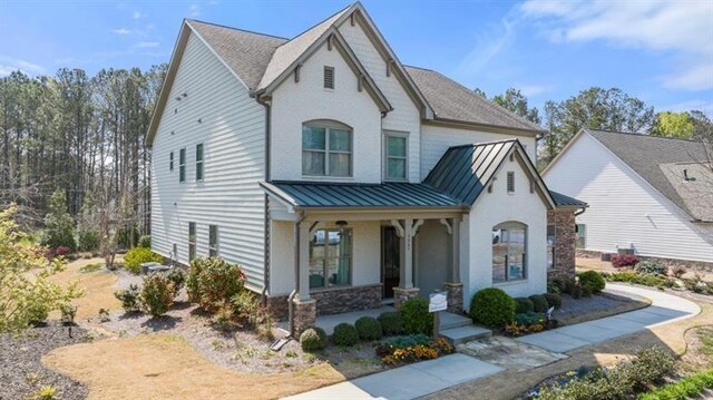 5247 Flannery Chase SW, Powder Springs, GA 30127 - view of front of house with a porch, a standing seam roof, metal roof, and stone siding