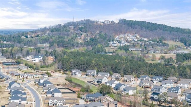 5247 Flannery Chase SW, Powder Springs, GA 30127 - aerial overview of property's location with nearby suburban area and a heavily wooded area