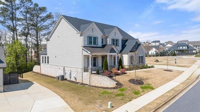 5247 Flannery Chase SW, Powder Springs, GA 30127 - view of front facade featuring stone siding, a residential view, and central air condition unit