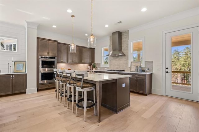 5247 Flannery Chase SW, Powder Springs, GA 30127 - kitchen with wall chimney range hood, light countertops, a sink, double oven, and dark brown cabinetry