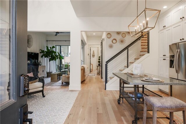 foyer with a notable chandelier and light hardwood / wood-style floors