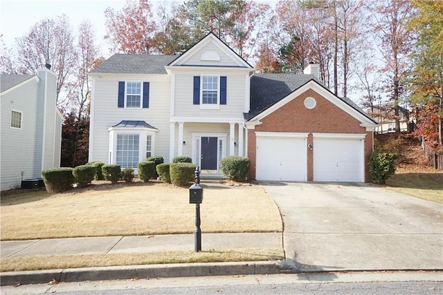 traditional home featuring an attached garage, central air condition unit, brick siding, driveway, and a chimney