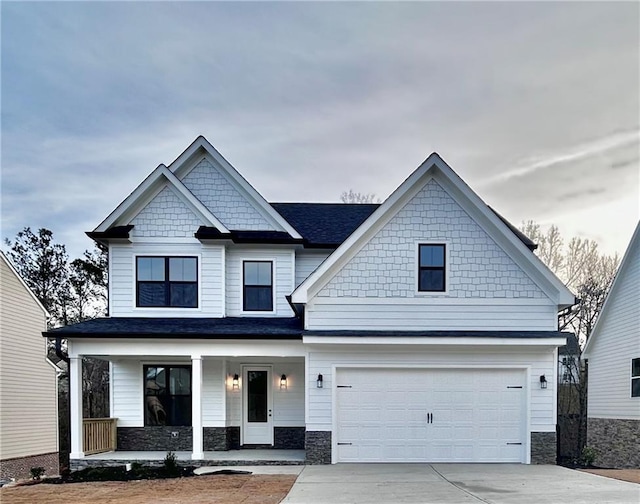 craftsman house with a porch and a garage