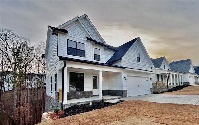 craftsman inspired home with a garage and covered porch