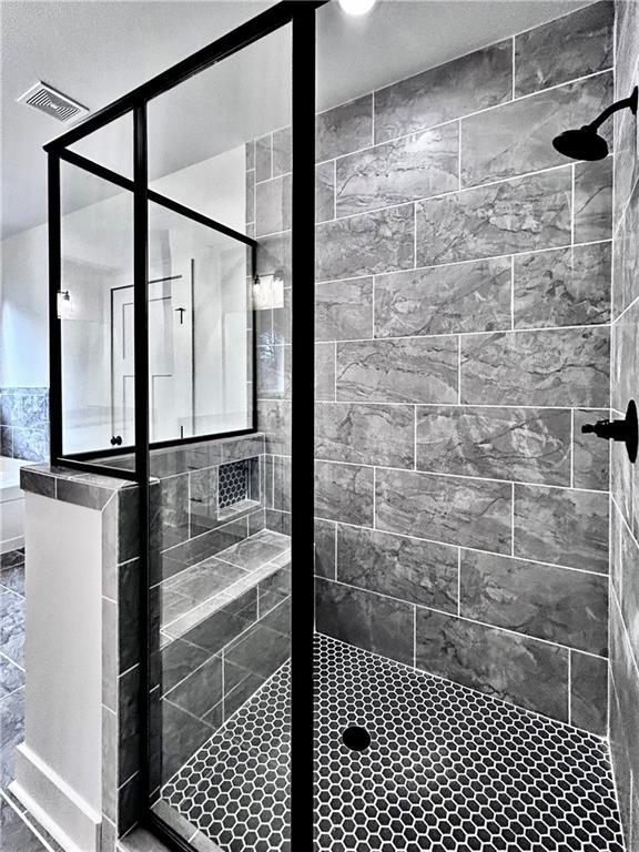 bathroom featuring tiled shower