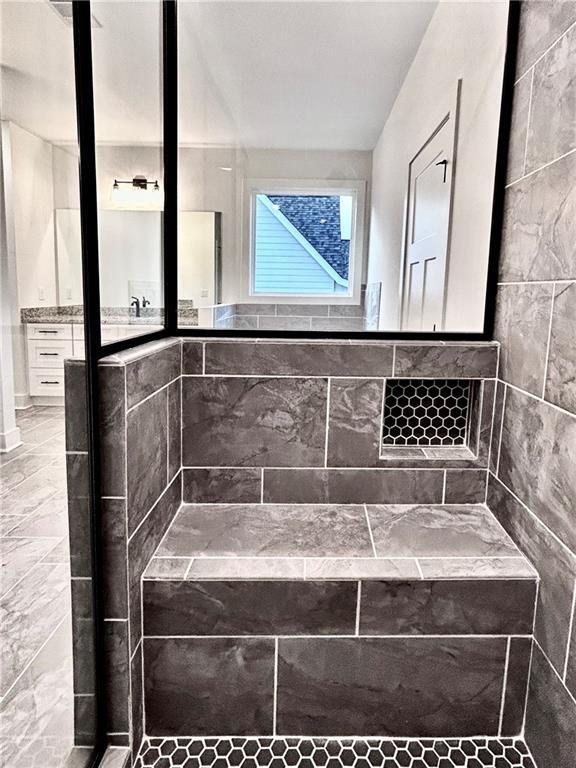 bathroom featuring vanity and a shower