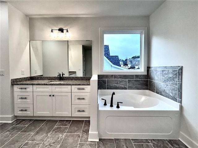 bathroom featuring a washtub and vanity