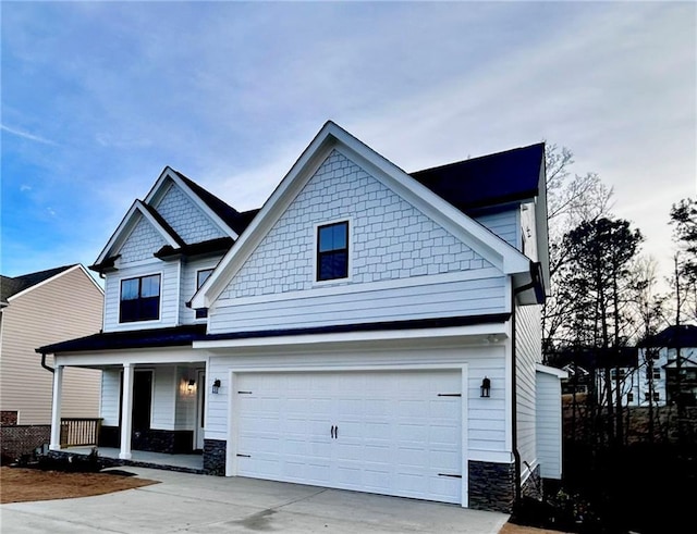 craftsman-style house with a garage and covered porch