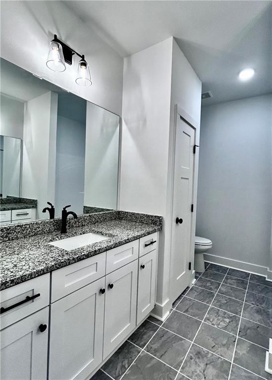 bathroom with vanity and toilet