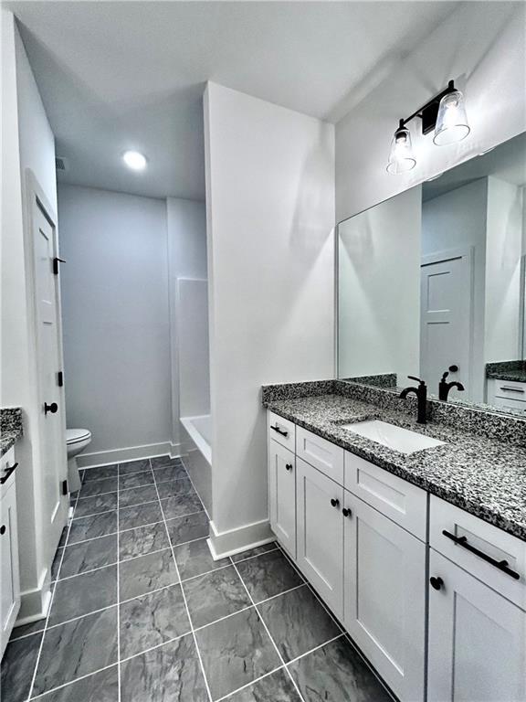 bathroom featuring vanity and toilet