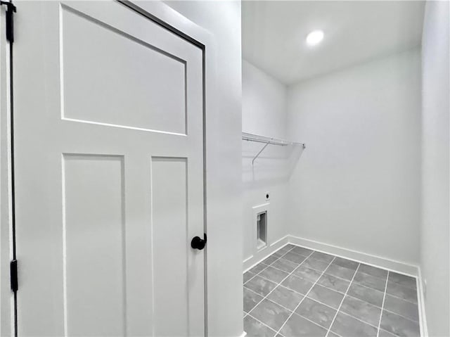 laundry area with hookup for an electric dryer and tile patterned floors