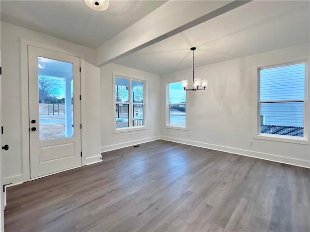 foyer entrance with beamed ceiling, dark hardwood / wood-style flooring, and a chandelier