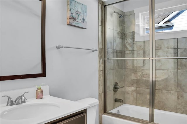 bathroom with enclosed tub / shower combo and vanity