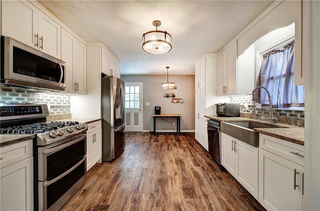 36 Skyview Cir, Cartersville, GA 30120 - kitchen featuring stainless steel appliances, a sink, tasteful backsplash, white cabinetry, and a textured ceiling