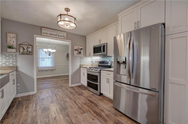 36 Skyview Cir, Cartersville, GA 30120 - kitchen with appliances with stainless steel finishes, a chandelier, white cabinets, and backsplash