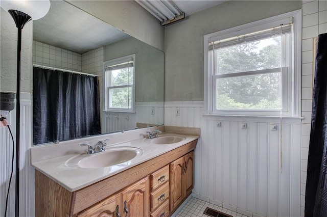 36 Skyview Cir, Cartersville, GA 30120 - full bathroom with wainscoting, double vanity, tile patterned floors, and a shower with shower curtain