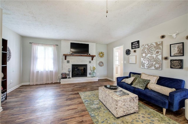 36 Skyview Cir, Cartersville, GA 30120 - living area with a textured ceiling, healthy amount of natural light, wood finished floors, a brick fireplace, and baseboards