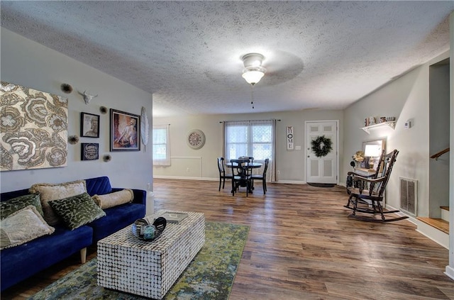 36 Skyview Cir, Cartersville, GA 30120 - living area with wood finished floors, a textured ceiling, baseboards, a ceiling fan, and stairs