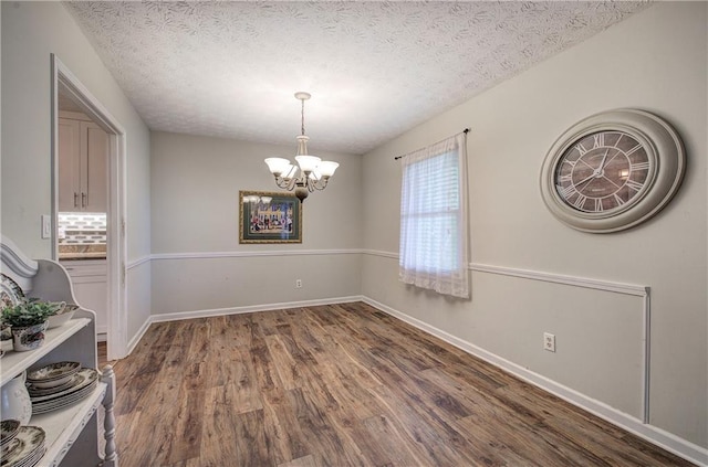 36 Skyview Cir, Cartersville, GA 30120 - unfurnished dining area featuring a chandelier, wood finished floors, a textured ceiling, and baseboards