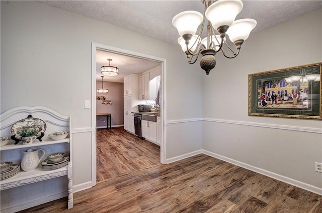 36 Skyview Cir, Cartersville, GA 30120 - unfurnished dining area featuring a chandelier, wood finished floors, a textured ceiling, and baseboards