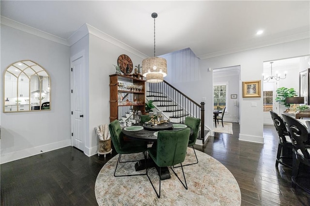 dining area featuring dark hardwood / wood-style floors, crown molding, and an inviting chandelier