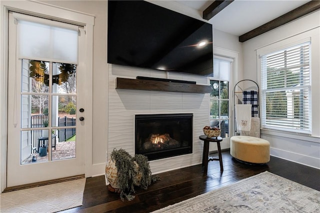 living room with beam ceiling and hardwood / wood-style floors